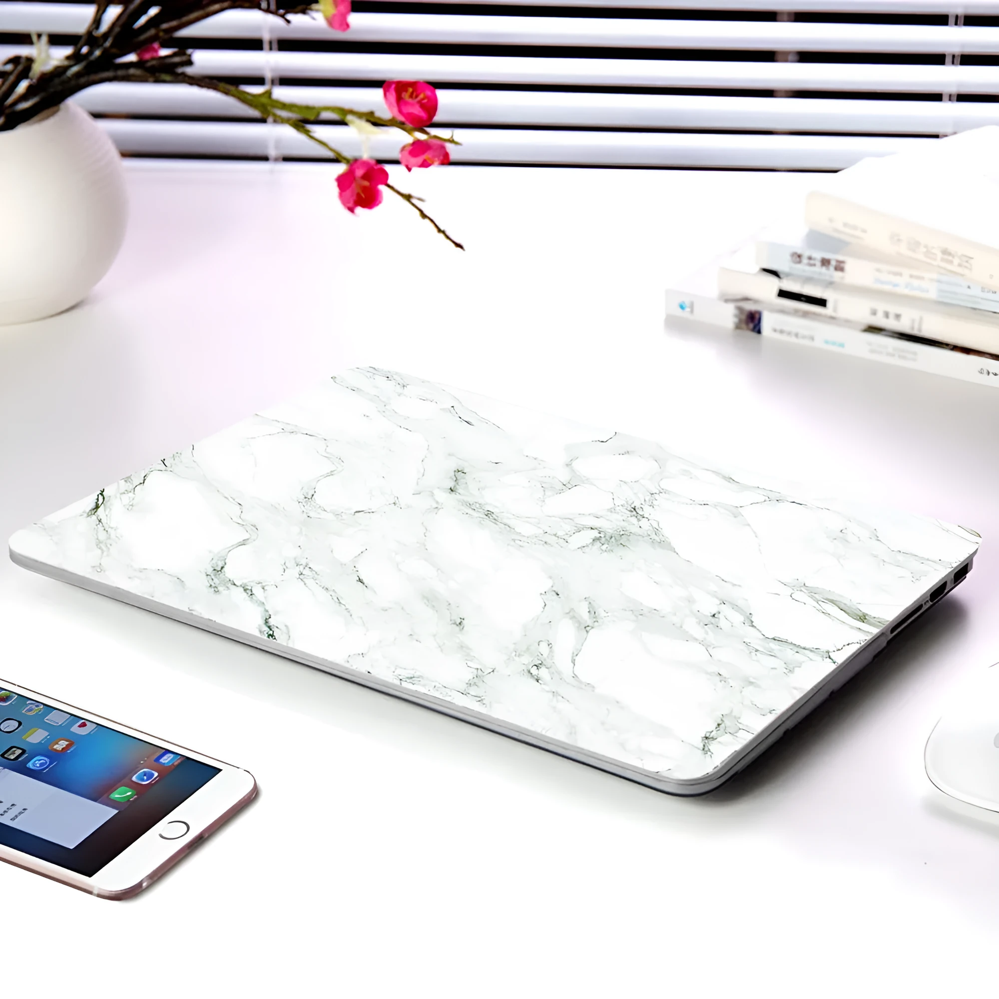 Plastic marble finish protective case for a MacBook laptop in light blue colour.