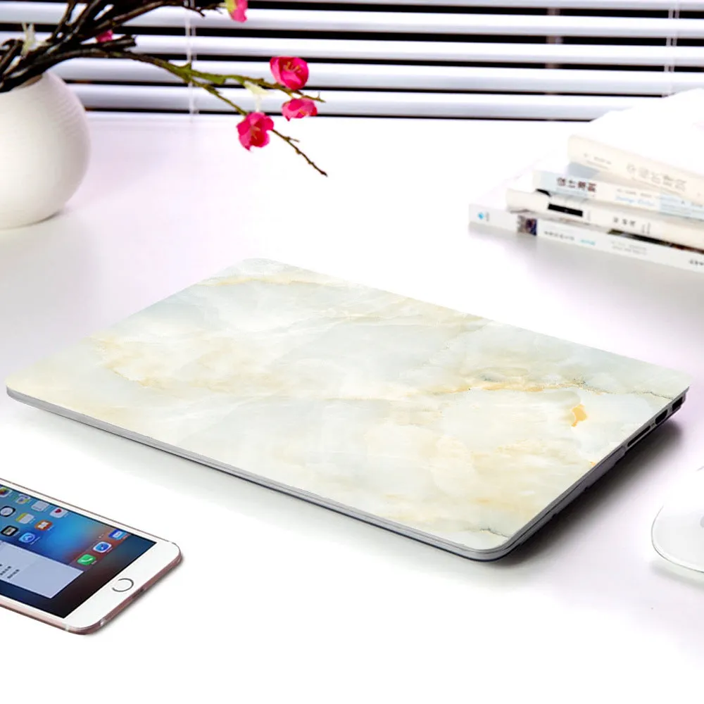 Plastic marble finish protective case for a MacBook laptop in light blue colour.