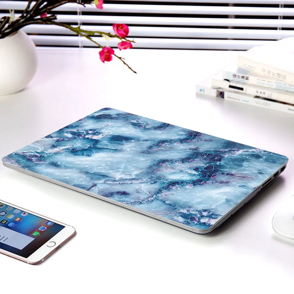 Plastic marble finish protective case for a MacBook laptop in light blue colour.