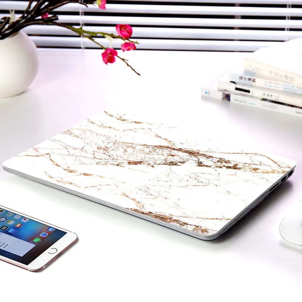 Plastic marble finish protective case for a MacBook laptop in light blue colour.