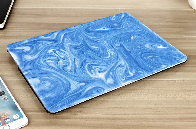 Plastic marble finish protective case for a MacBook laptop in light blue colour.
