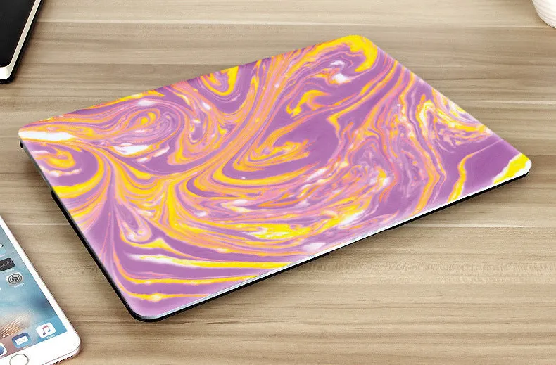 Plastic marble finish protective case for a MacBook laptop in light blue colour.
