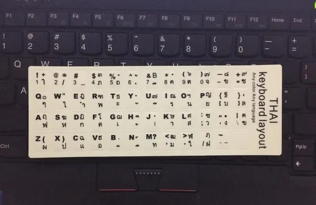 Yellow glowing PVC keyboard stickers with Arabic, Thai, Hebrew, French, Italian, and German language characters