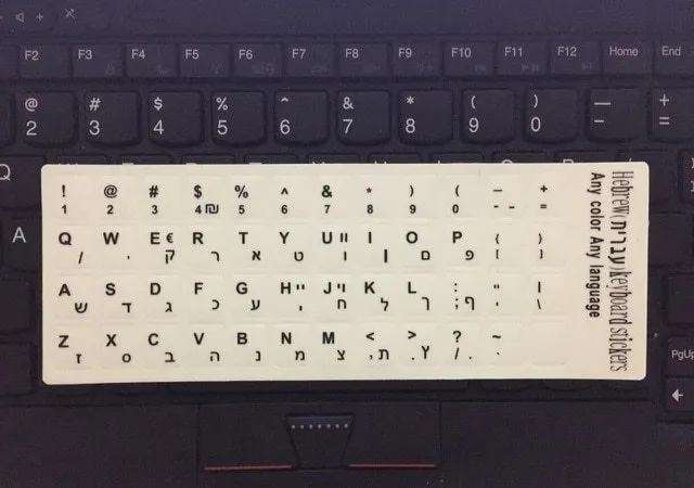 Yellow glowing PVC keyboard stickers with Arabic, Thai, Hebrew, French, Italian, and German language characters