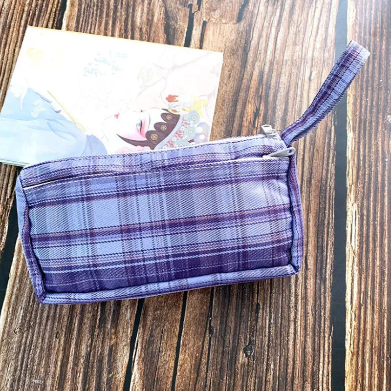 Square double-layer canvas stationery bag in a red stripe grid pattern.