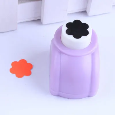 Children's plastic embossing craft kit with device and 20 embossing plates including heart, star, and elephant designs.