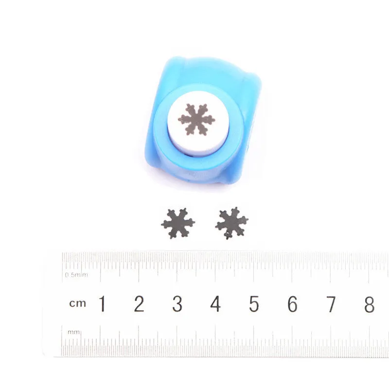 Children's plastic embossing craft kit with device and 20 embossing plates including heart, star, and elephant designs.