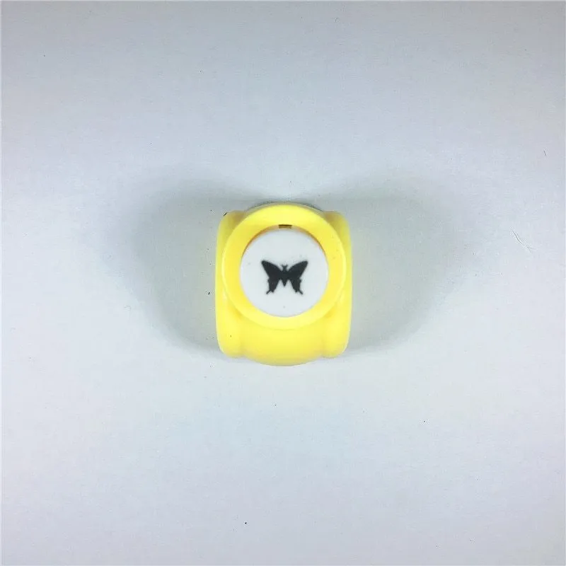 Children's plastic embossing craft kit with device and 20 embossing plates including heart, star, and elephant designs.