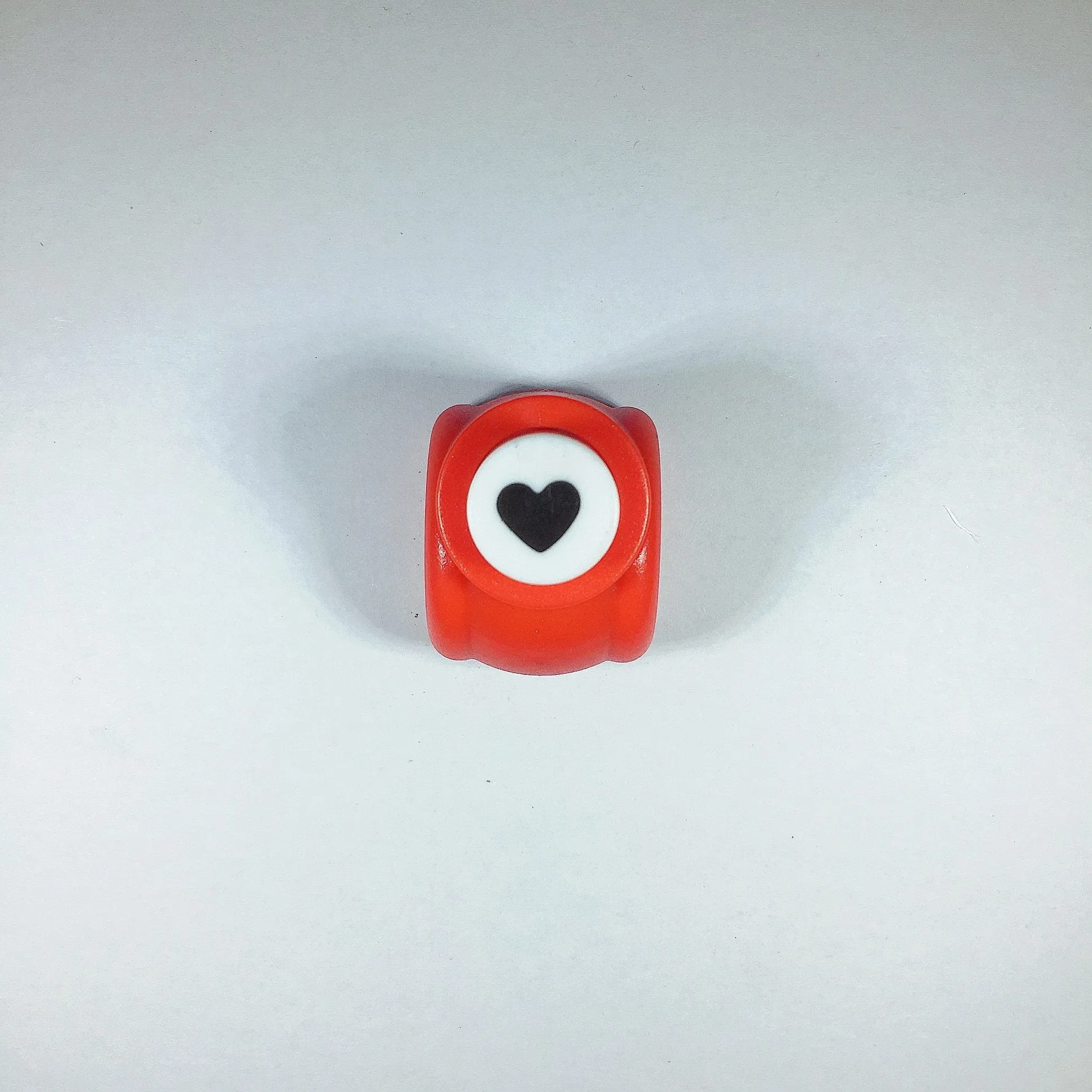 Children's plastic embossing craft kit with device and 20 embossing plates including heart, star, and elephant designs.