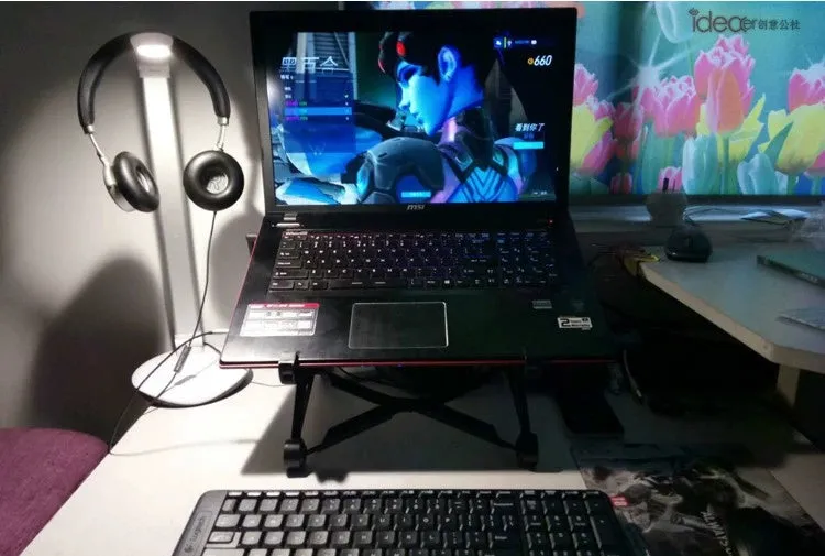 Black foldable laptop stand with height adjustment and protective nylon carrying case