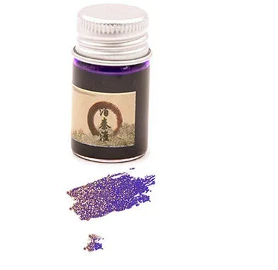 Set of six small glass bottles of gold powder dipping pen ink in different colours.