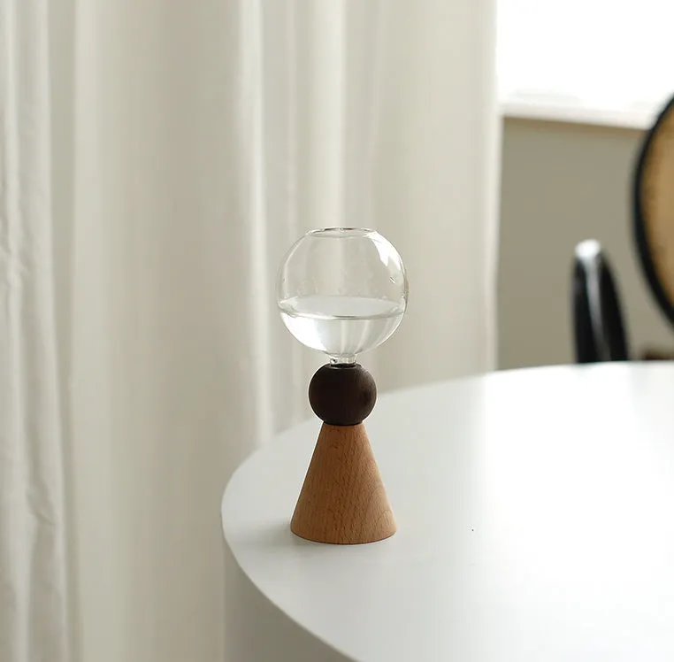 Clear glass Nordic geometric bubble vase with choice of conical base or curved arc base on a wooden table.
