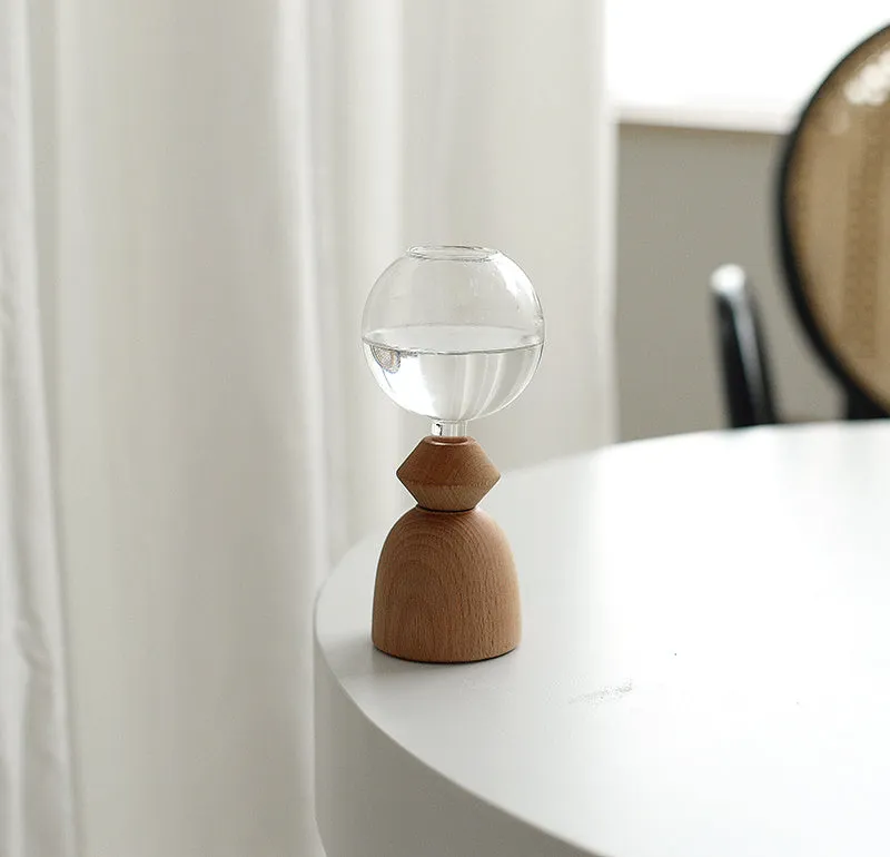 Clear glass Nordic geometric bubble vase with choice of conical base or curved arc base on a wooden table.