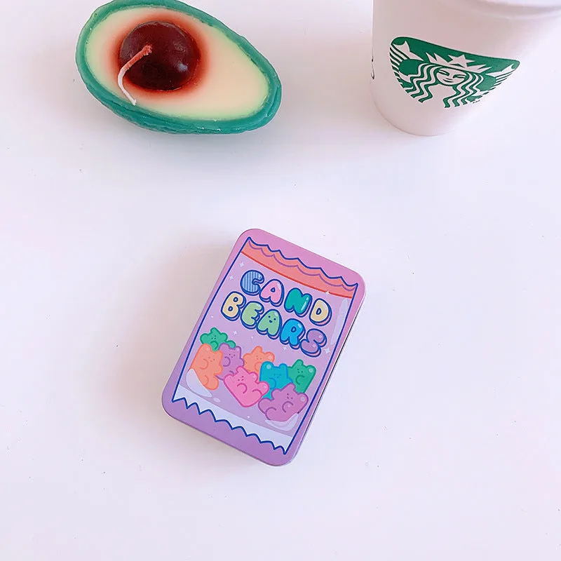Small decorative iron storage tin box with a colourful printed lid, shown closed.