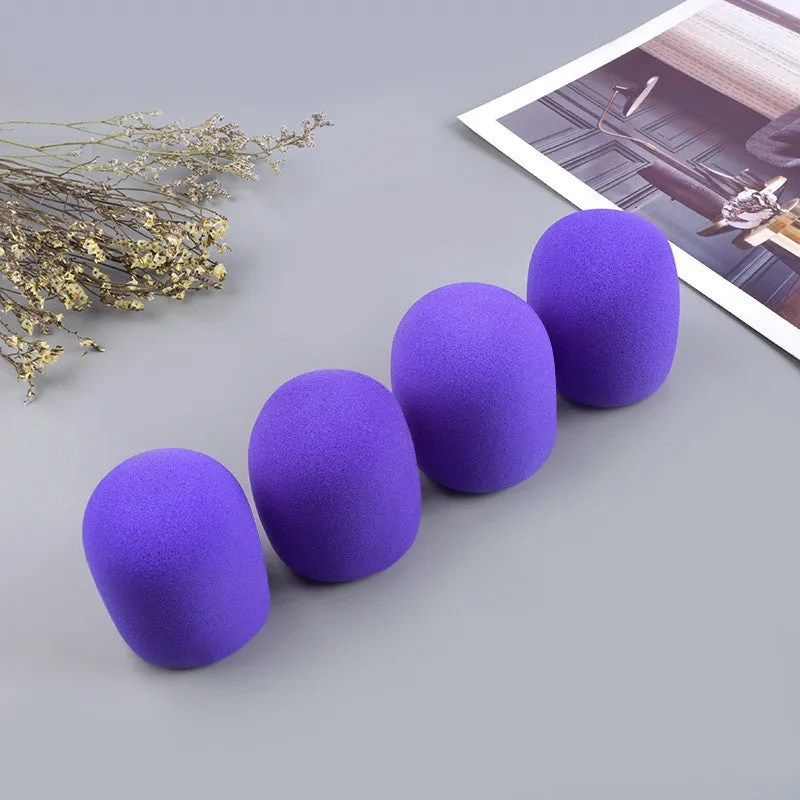 Four multicoloured foam microphone windshields for handheld stage microphones