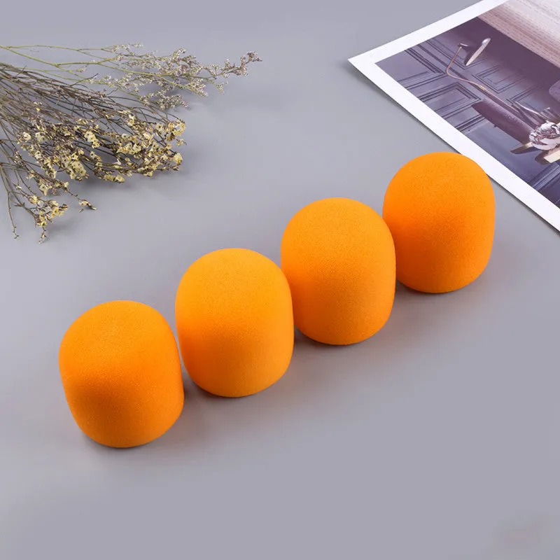 Four multicoloured foam microphone windshields for handheld stage microphones