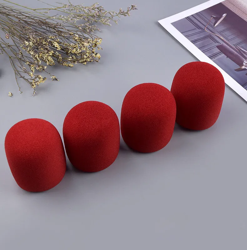 Four multicoloured foam microphone windshields for handheld stage microphones