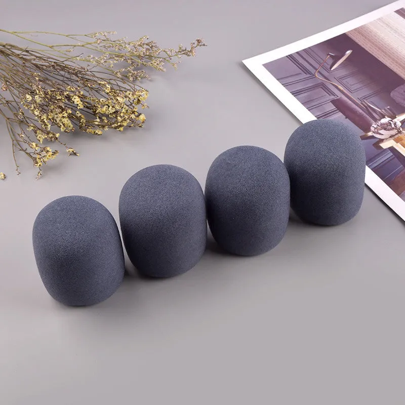 Four multicoloured foam microphone windshields for handheld stage microphones