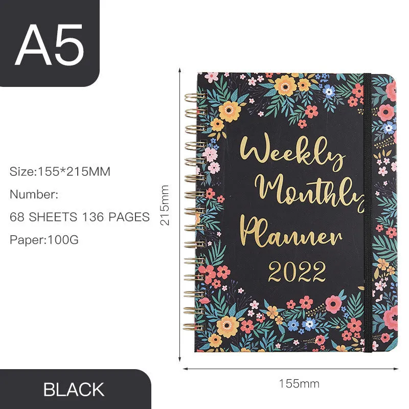 A5 spiral notebook with colourful floral cover, open to show lined pages and metal coil binding