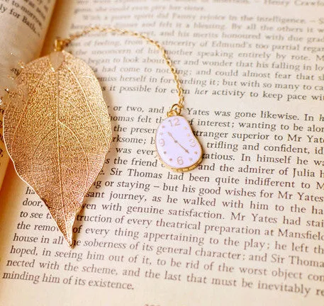 Three decorative alloy bookmarks featuring Alice, rabbit and clock designs on a leaf-shaped base
