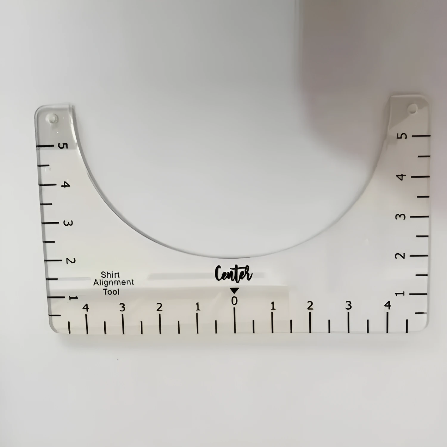 Clear acrylic sewing patch ruler for T-shirt alignment, 10 by 6 inches.