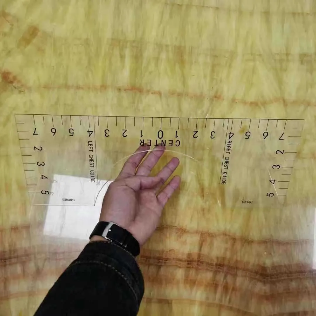 Clear acrylic sewing patch ruler for T-shirt alignment, 10 by 6 inches.