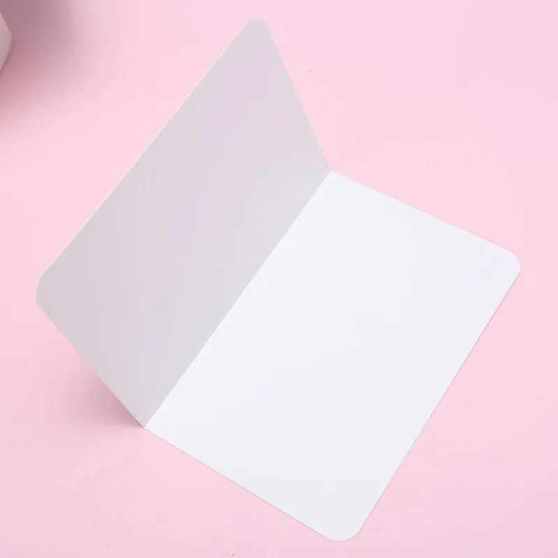 A pack of 100 blank folded kraft paper cards in 10x15cm size, shown in black, brown, and white colours.