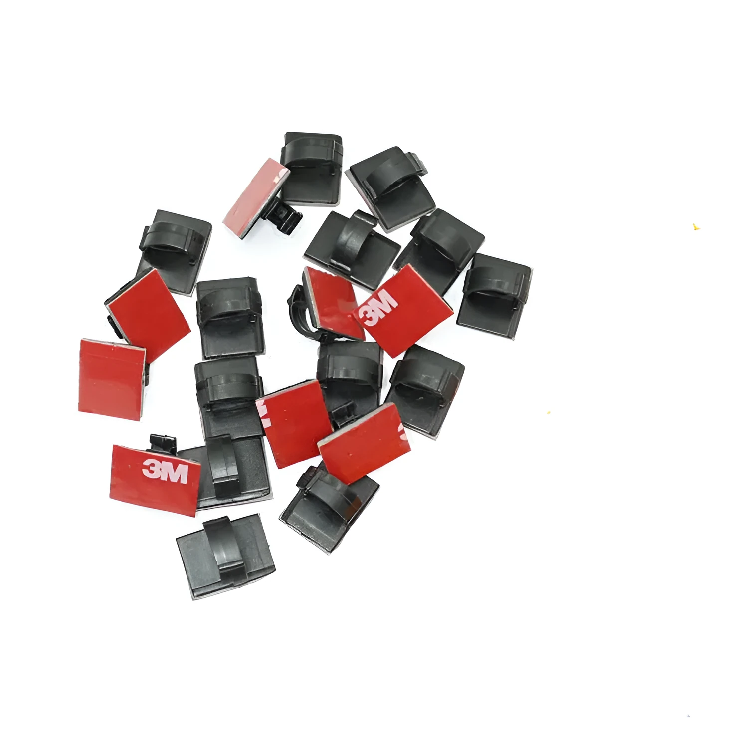 Black and white self-adhesive plastic flat cable clamps for wire organisation.