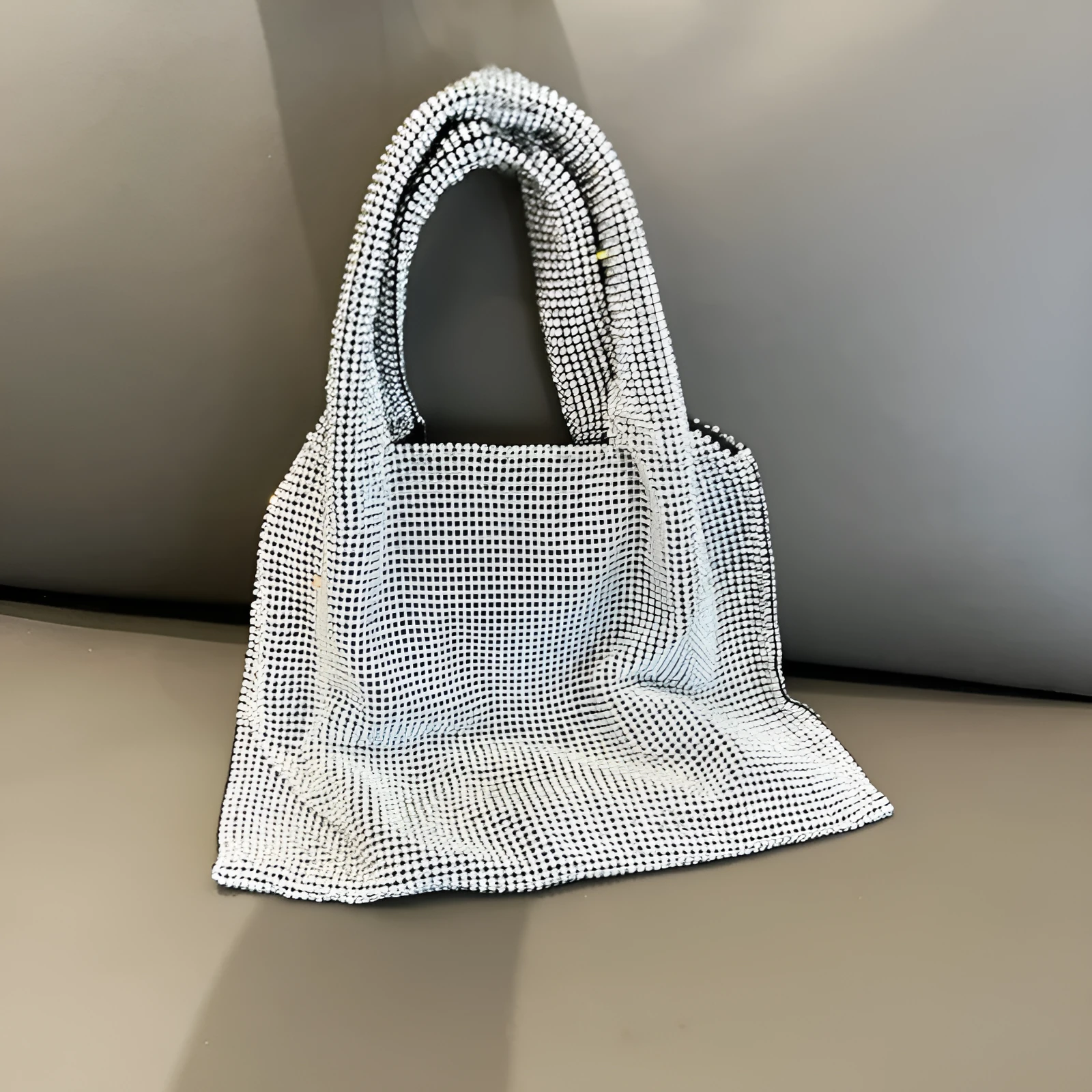 Silver evening handbag with shiny rhinestone decoration and cotton thread construction