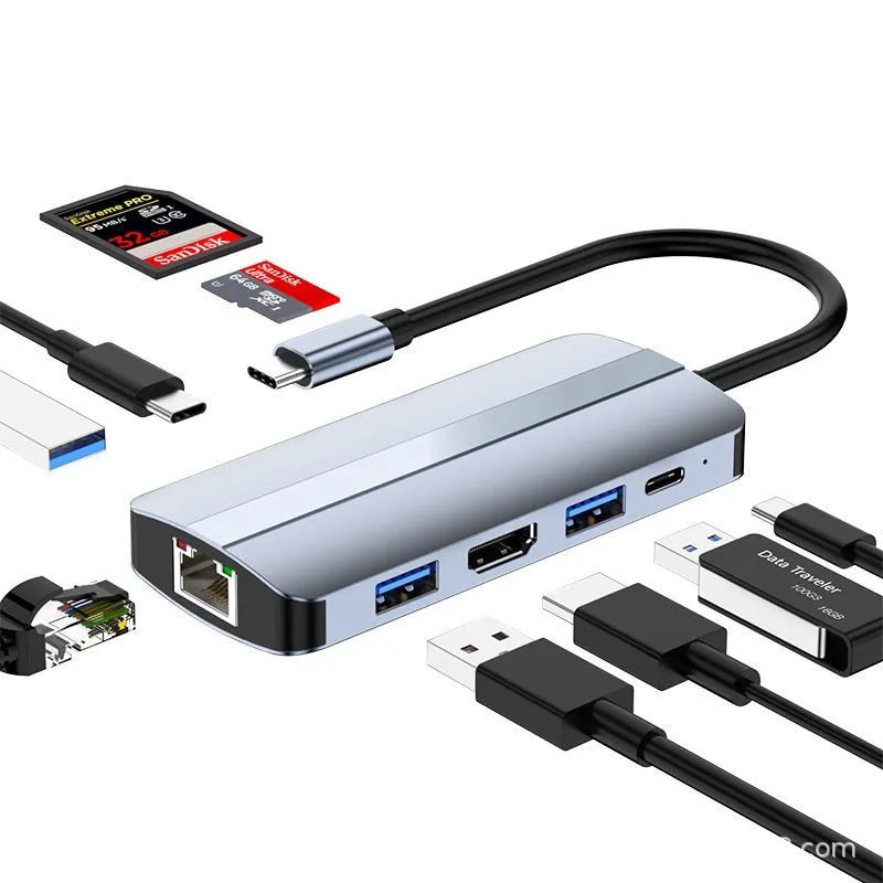 Silver USB-C 7-in-1 expansion dock with HDMI, USB ports, card slots, Ethernet, and a 15 cm cable.