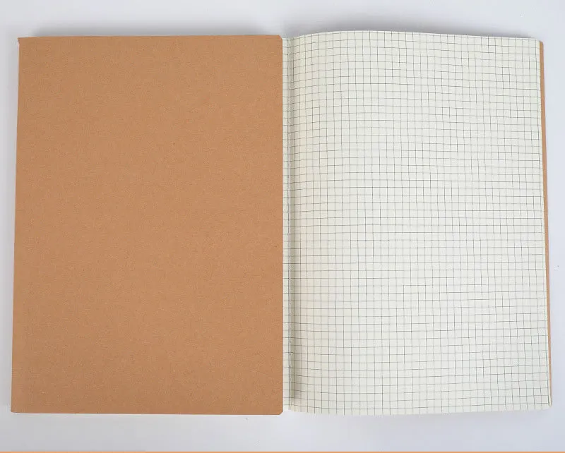 Beige softcover thread-bound notebook in 16K size lying open on a table, showing grid paper inside.