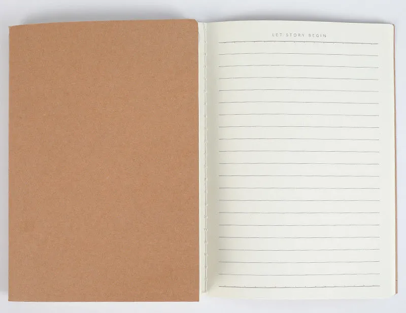 Beige softcover thread-bound notebook in 16K size lying open on a table, showing grid paper inside.