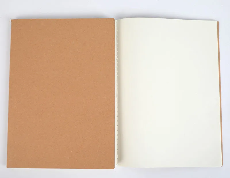 Beige softcover thread-bound notebook in 16K size lying open on a table, showing grid paper inside.