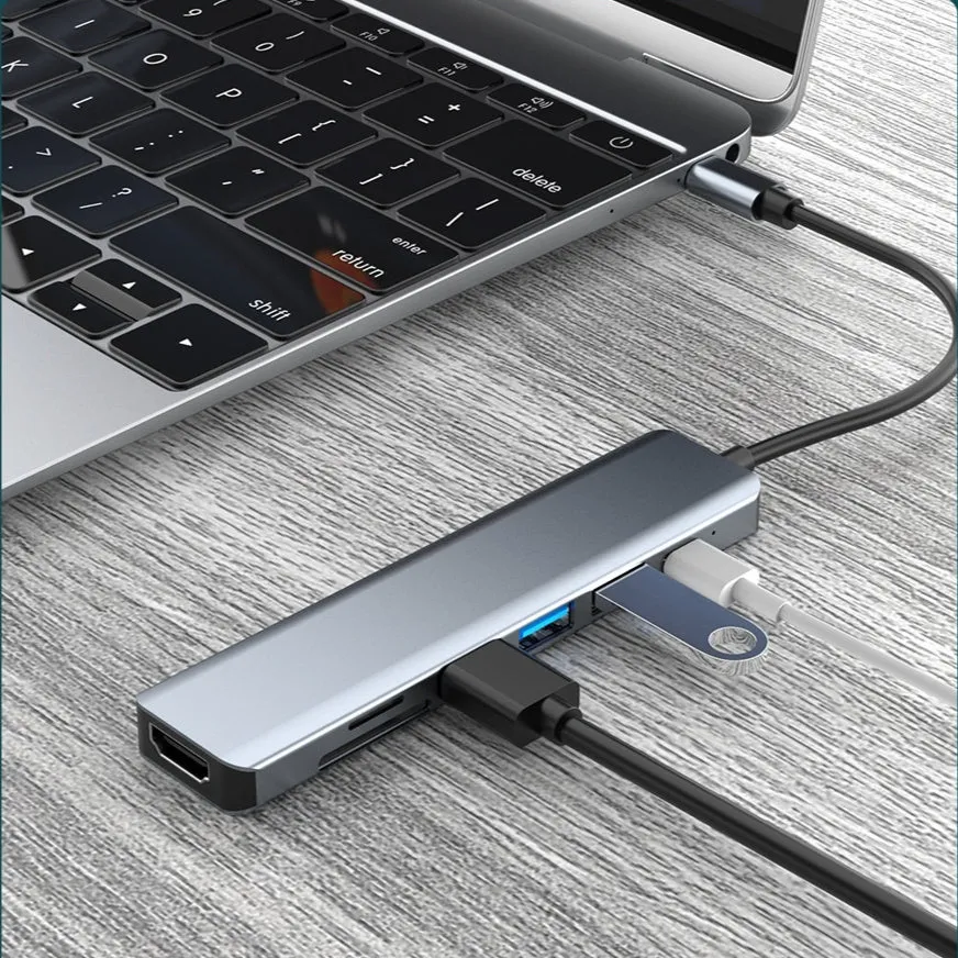 Seven-port USB expander with a short Type-C cable connected to a laptop.