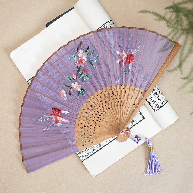 Traditional Chinese embroidered silk folding fan with bamboo frame showing detailed Su embroidery pattern