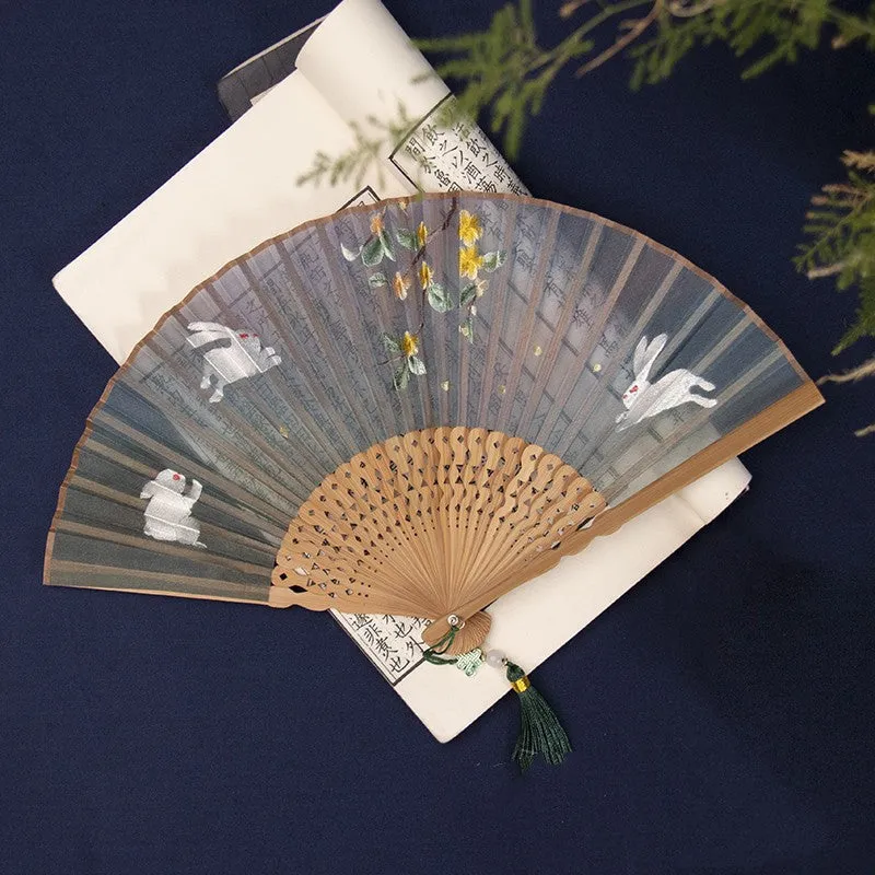 Traditional Chinese embroidered silk folding fan with bamboo frame showing detailed Su embroidery pattern