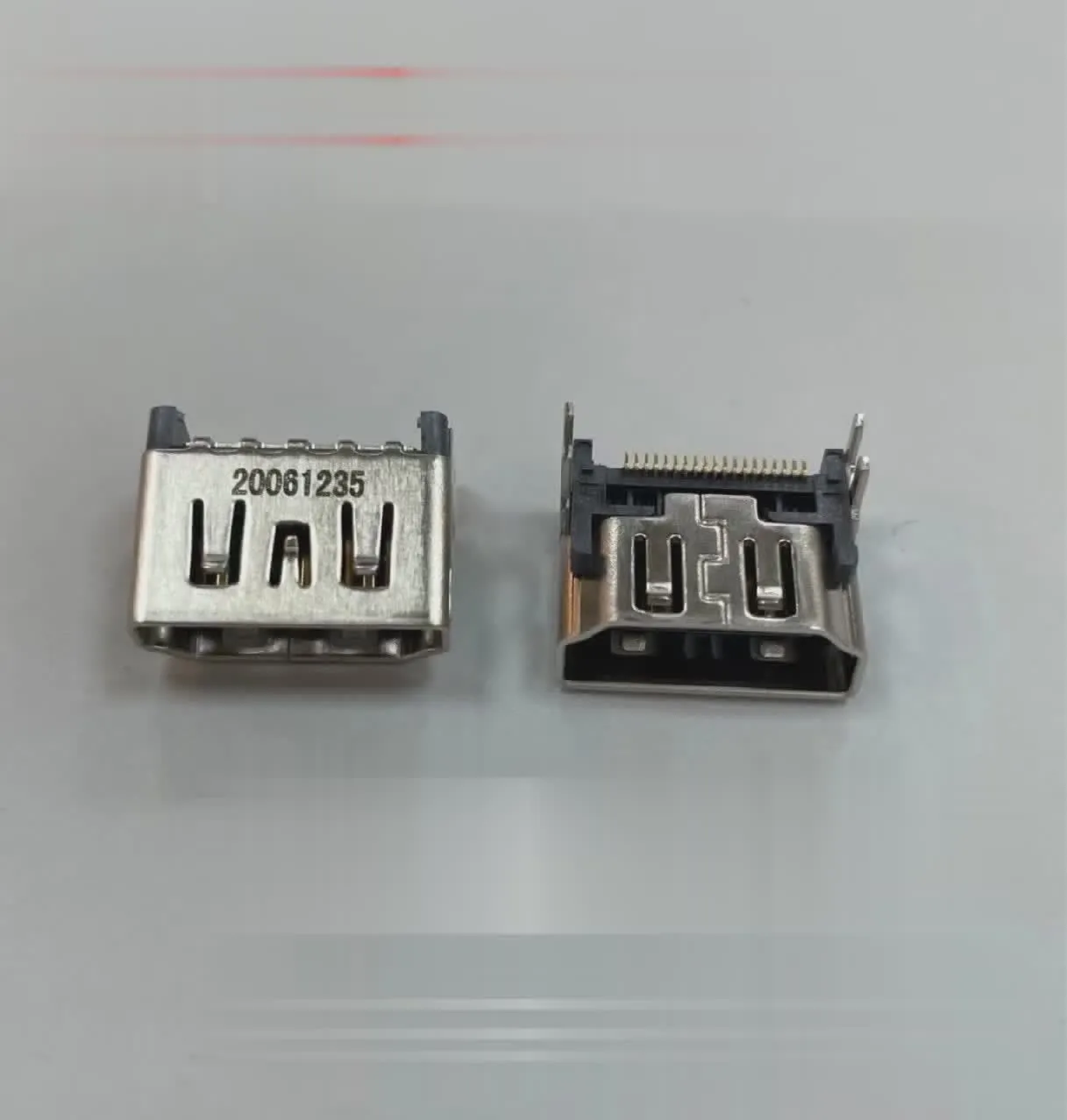 Silver metal HDMI host interface socket connector with mounting holes.