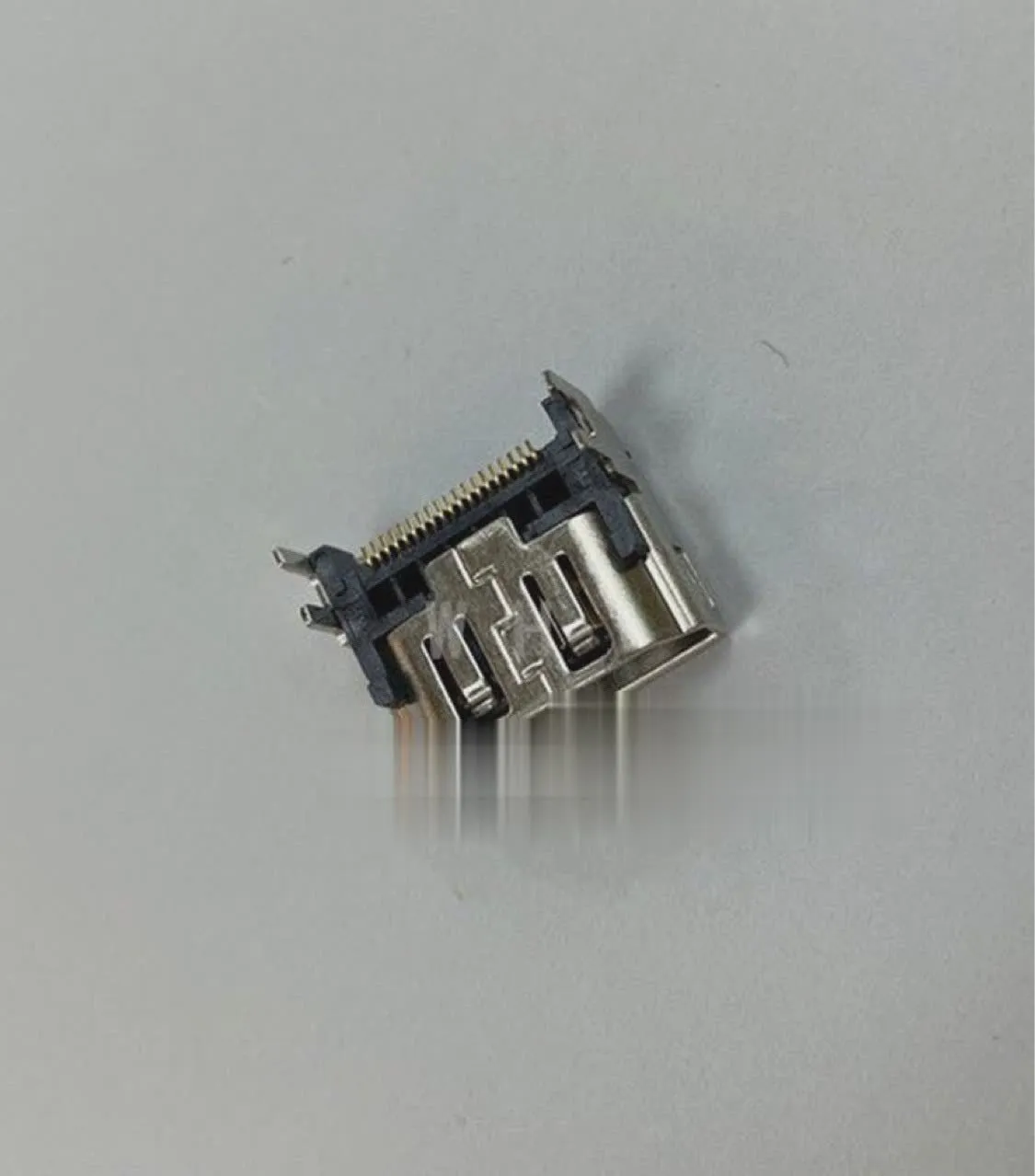 Silver metal HDMI host interface socket connector with mounting holes.