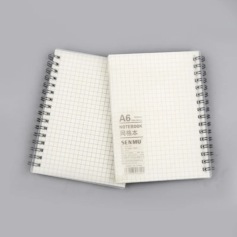 Creative coil-bound notebook open showing grid dot matrix pages, with PP matte cover in A5 size.
