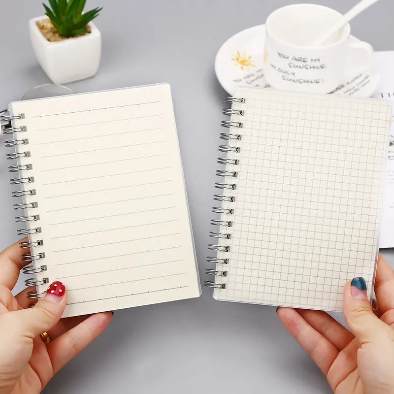 Creative coil-bound notebook open showing grid dot matrix pages, with PP matte cover in A5 size.