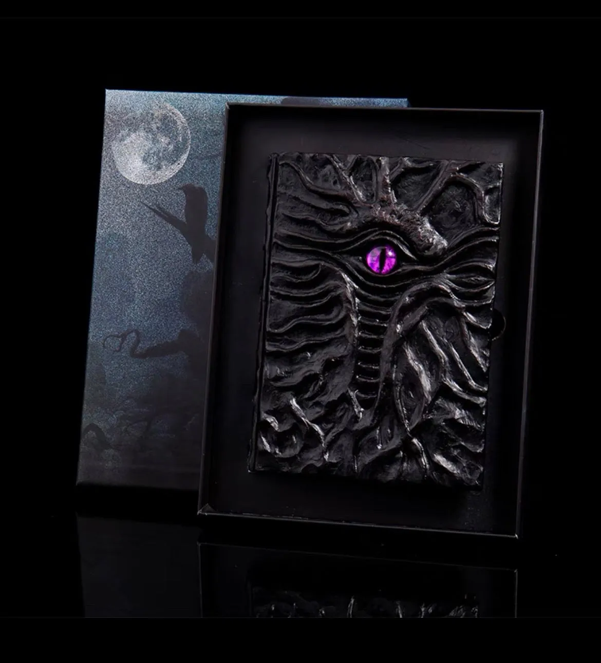Demon Eye Cthulhu embossed notebook with dark kraft paper cover, open to show Daolin paper pages.