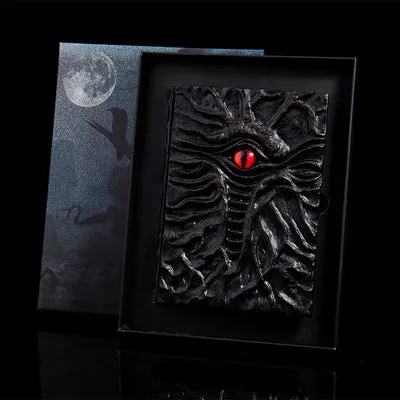 Demon Eye Cthulhu embossed notebook with dark kraft paper cover, open to show Daolin paper pages.
