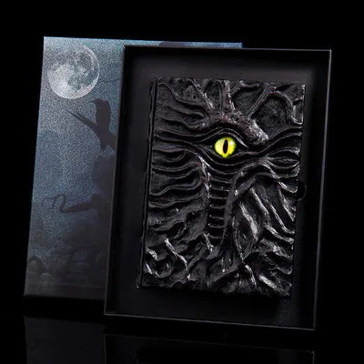 Demon Eye Cthulhu embossed notebook with dark kraft paper cover, open to show Daolin paper pages.