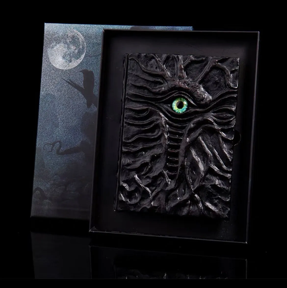Demon Eye Cthulhu embossed notebook with dark kraft paper cover, open to show Daolin paper pages.