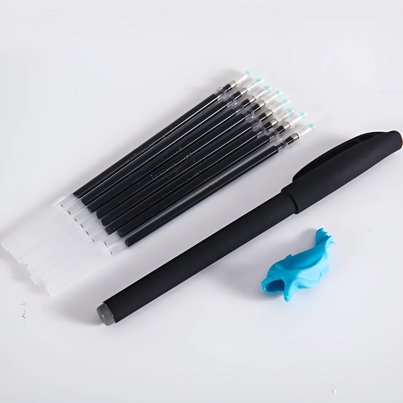 Automatic fade and disappear pen set showing pen holder, case, and eight refill cartridges of vanishing ink