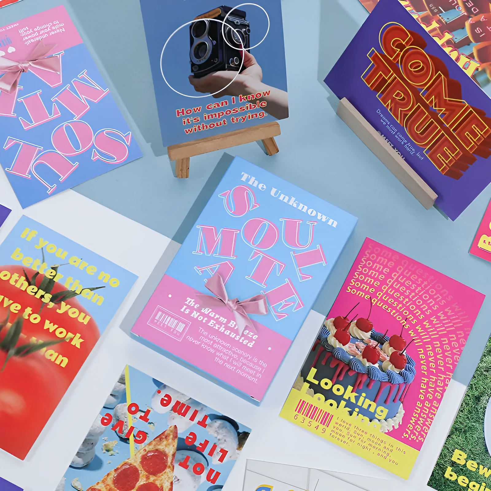 Box of fresh style creative postcards showing two different printed message designs.