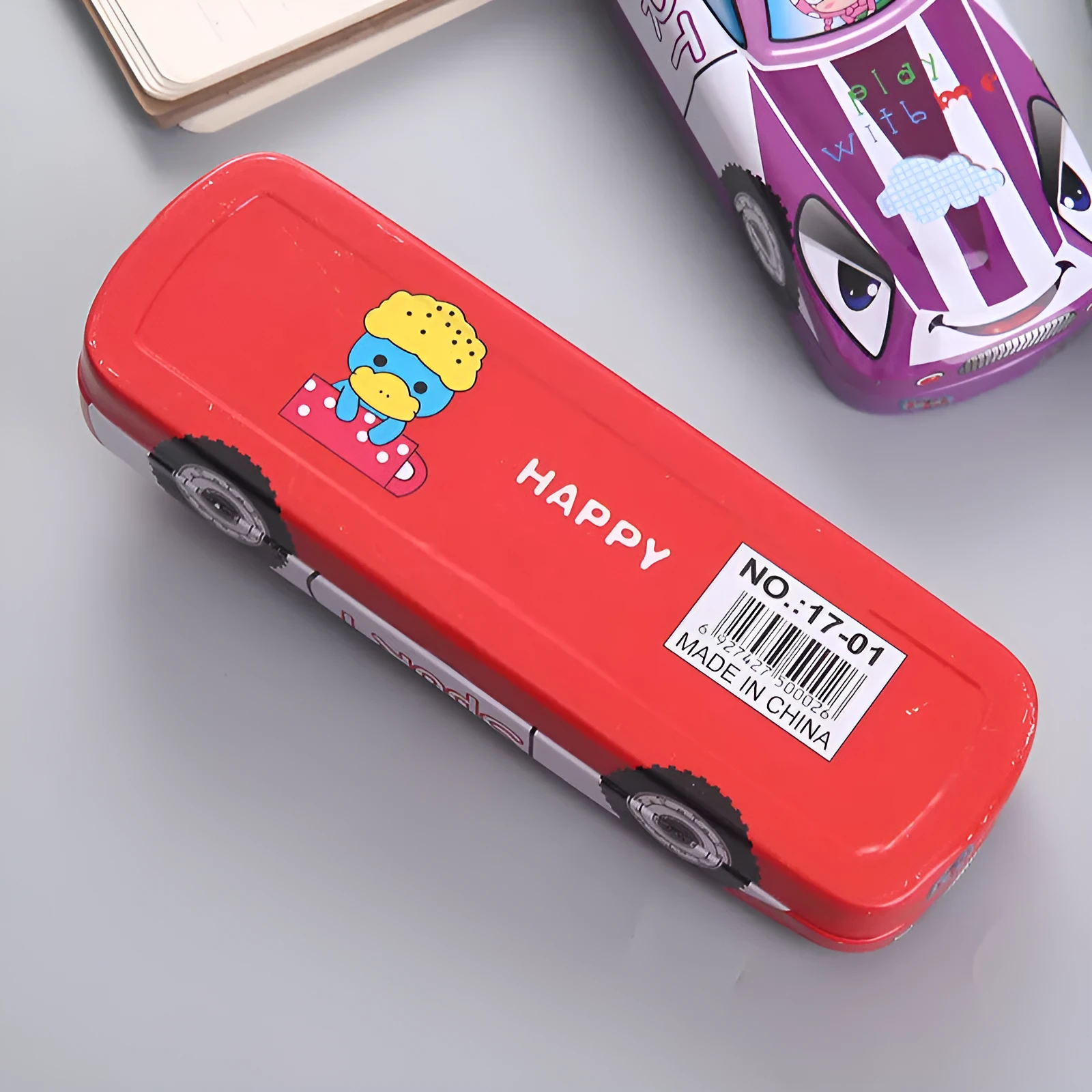 Metal tinplate stationery box with racing car trolley cartoon pattern, shown closed.