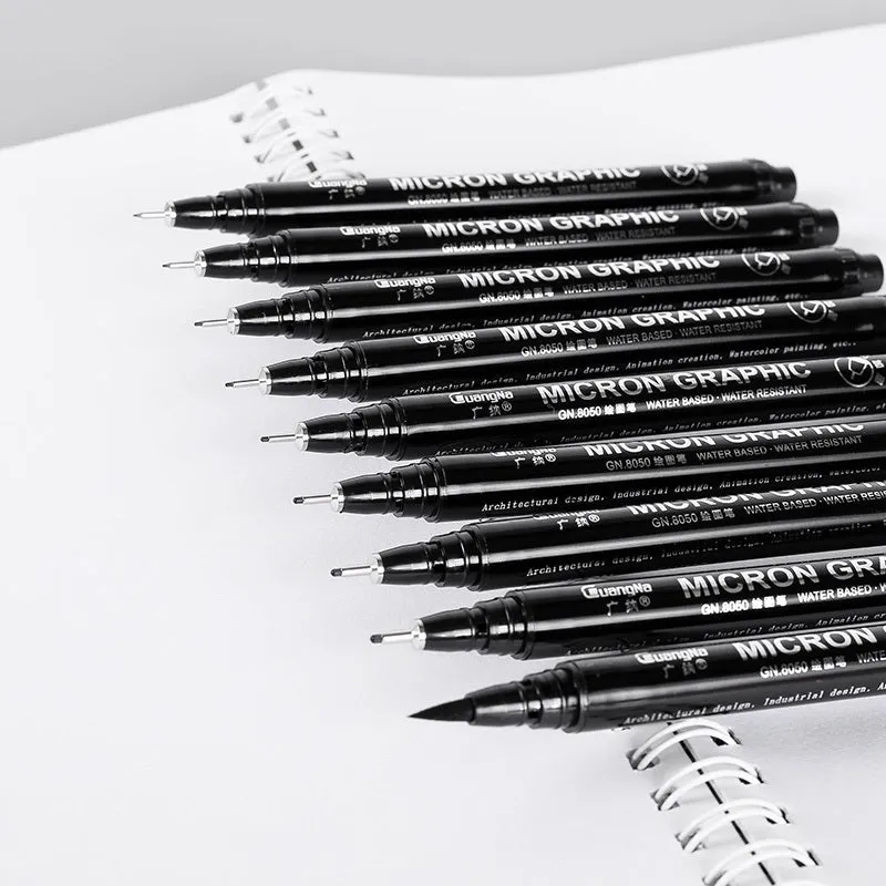 Set of 12 black comic drawing pens with various nib sizes stored in a fabric organiser bag.