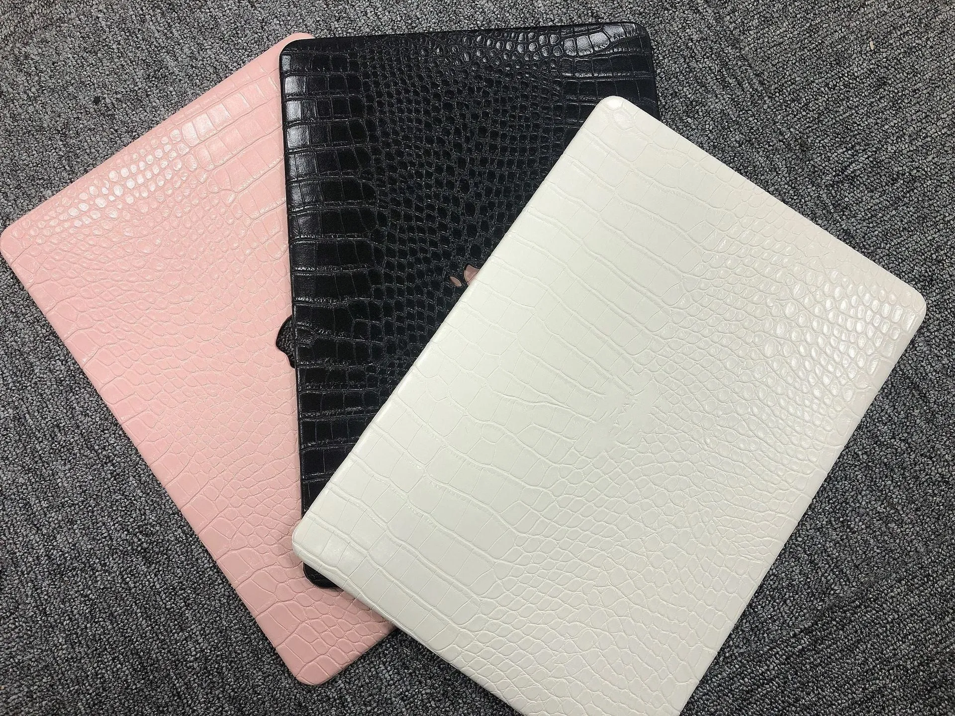 MacBook laptop protective case with leather pattern texture and hollowed-out Apple logo in black colour