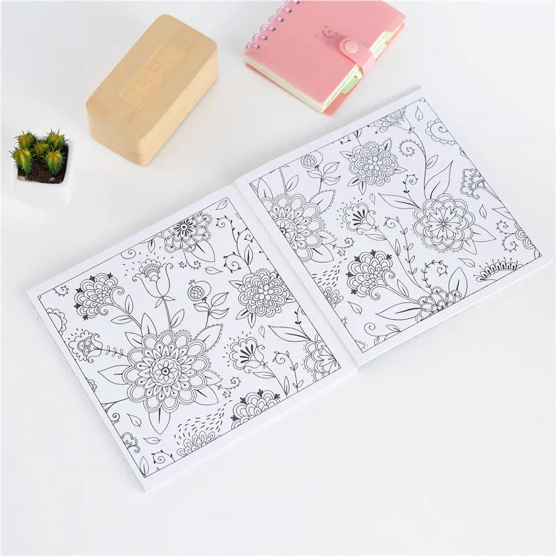 A5 mandala colouring book open showing black ink patterns on white paper with soft binder cover